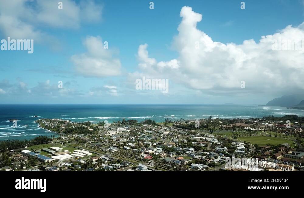 Laie seaside town with mountain background on O'ahu, Hawaii, aerial