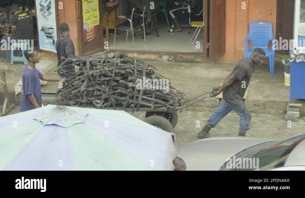 People pulling spare parts on truck in Ghana Stock Video Footage Alamy