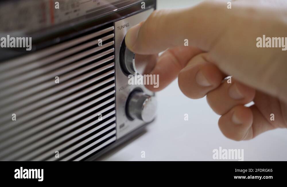 Hand tuning radio frequency knob changing stations old radio