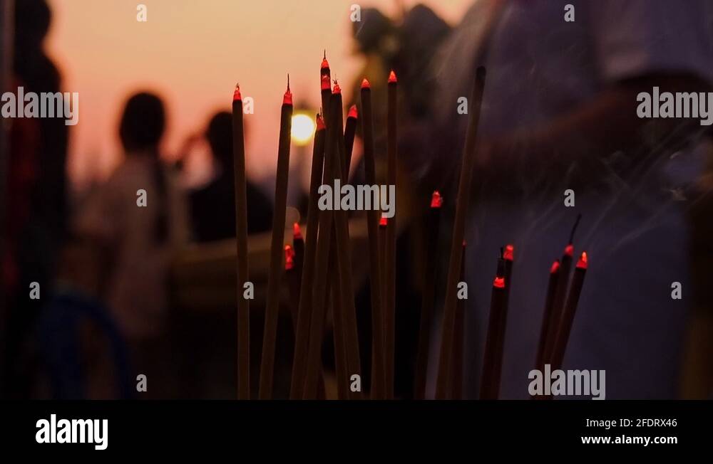 People in Cambodia burning incense to symbolize their faith and prayers