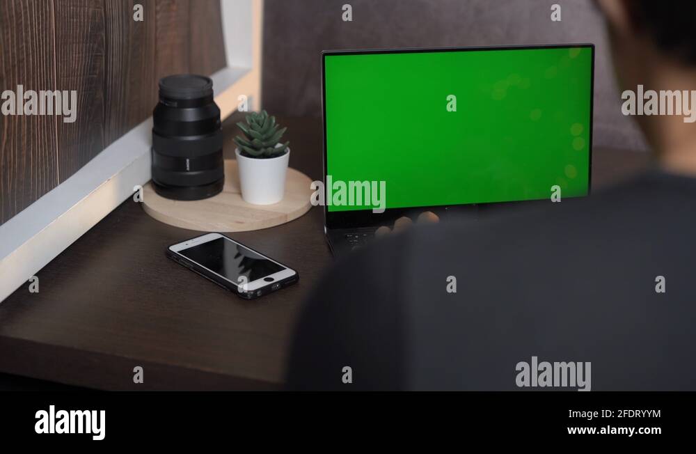 Green screen computer laptop, man working during home quarantine covid