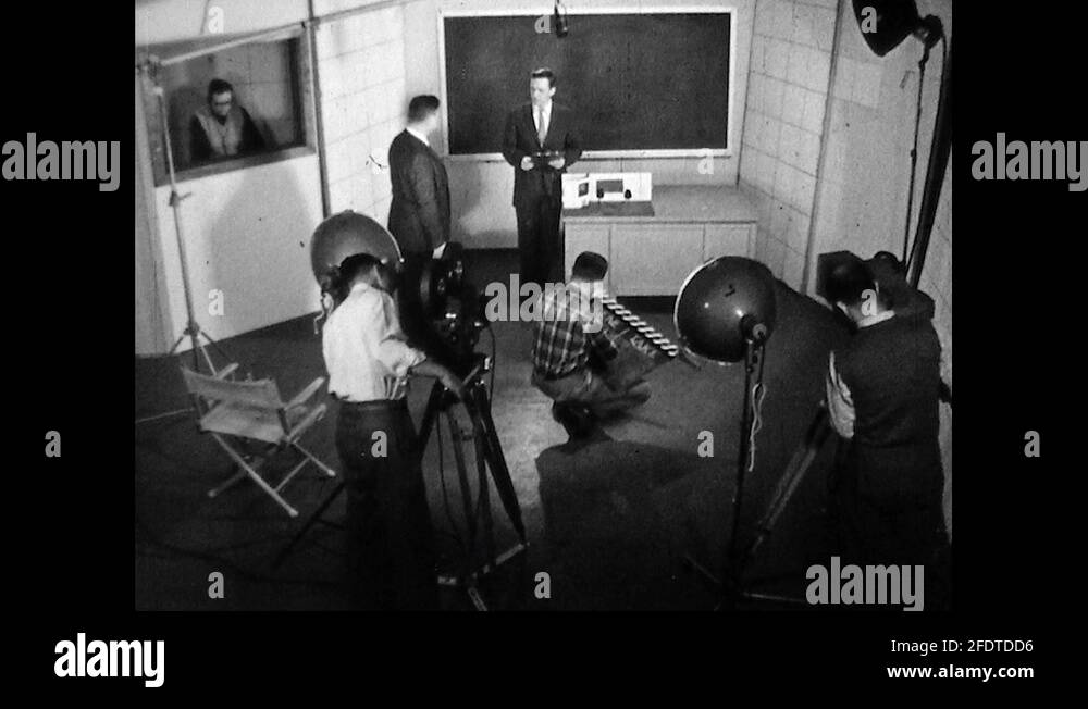 1950s: Production crew adjust cameras and clapboard in small film ...