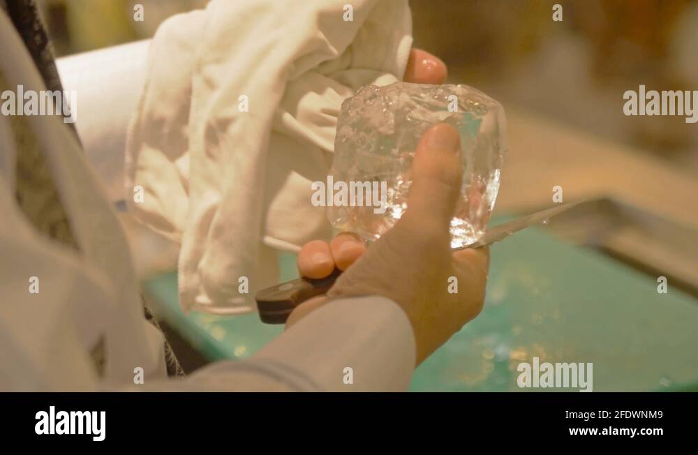 man carving ice cube while using a cloth static Stock Video Footage