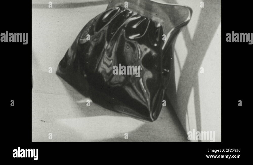 1950s Purse sitting on seat of car. Man hitches wrecked car at scene