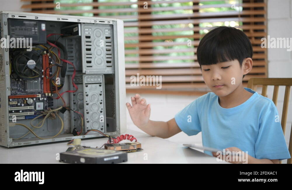 Educational concept. The boy is learning to repair the computer using a