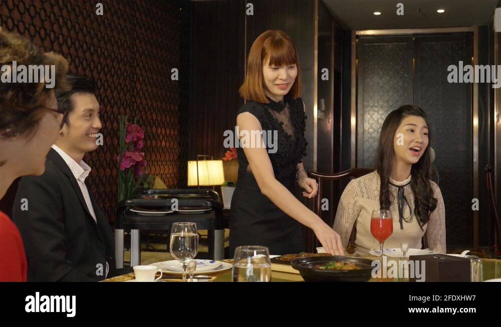 A Female Waiter Is Turning The Table To Arrange Food Stock Video