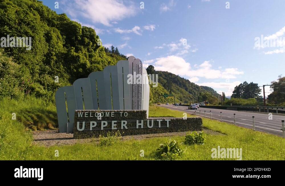to Upper Hutt Sign with Train Driving past Next to State