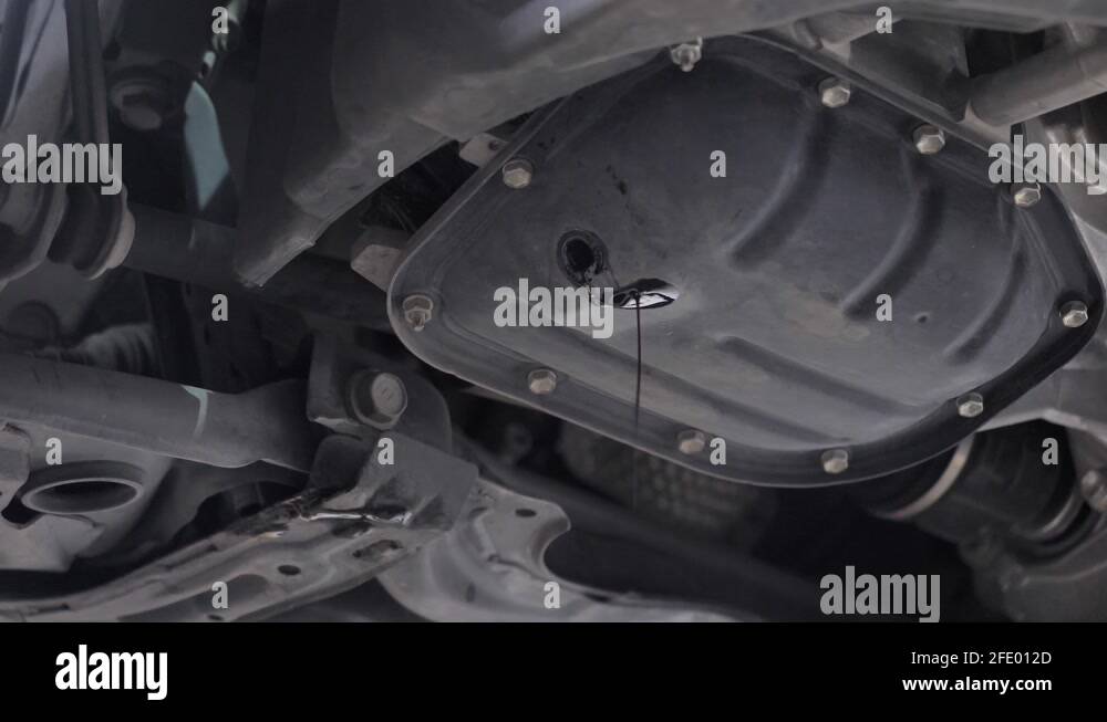 Engine oil dripping from hole in sump Stock Video Footage Alamy