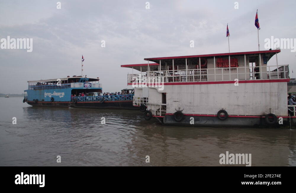 Ferry Taking off and landing on the Tonle Sap river in Phnom Penh Stock