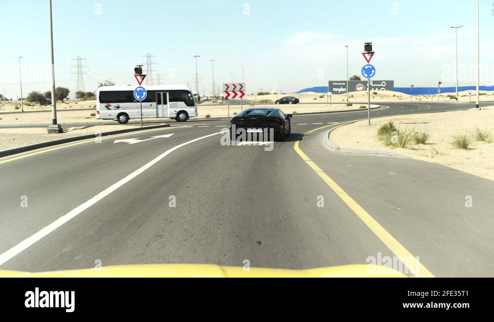 Wide angle following driving around Dubai roundabout Stock