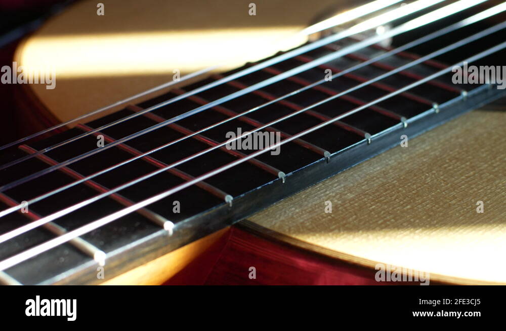 Guitar fretboard with frets and strings close up sliding shot towards the Stock Video Footage