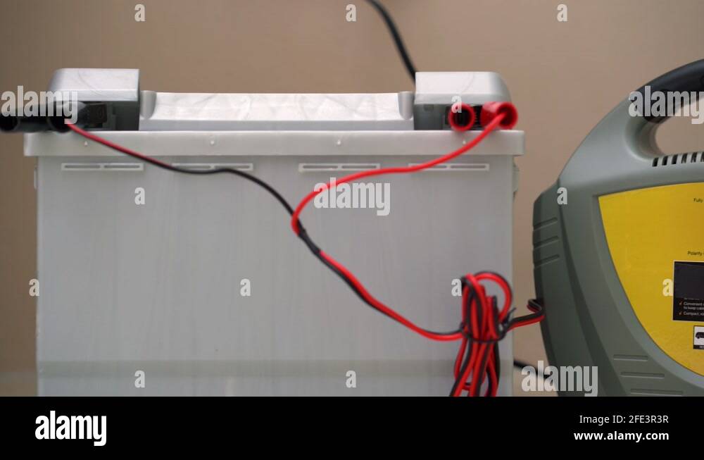Car battery being charged with mains charger using positive and