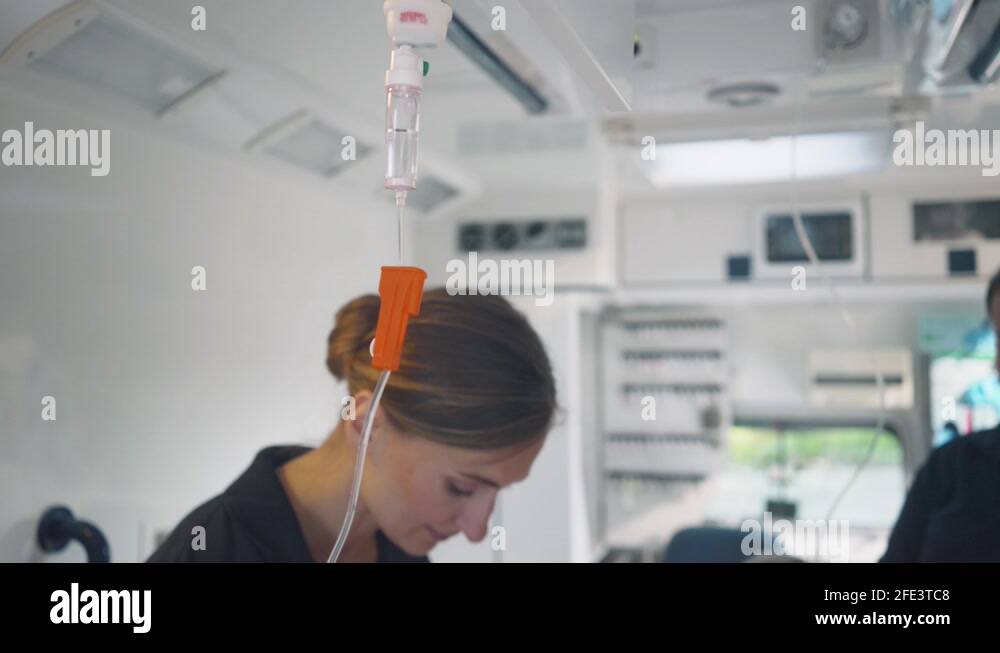 Paramedic looking after the drop injection in an ambulance Stock Video ...