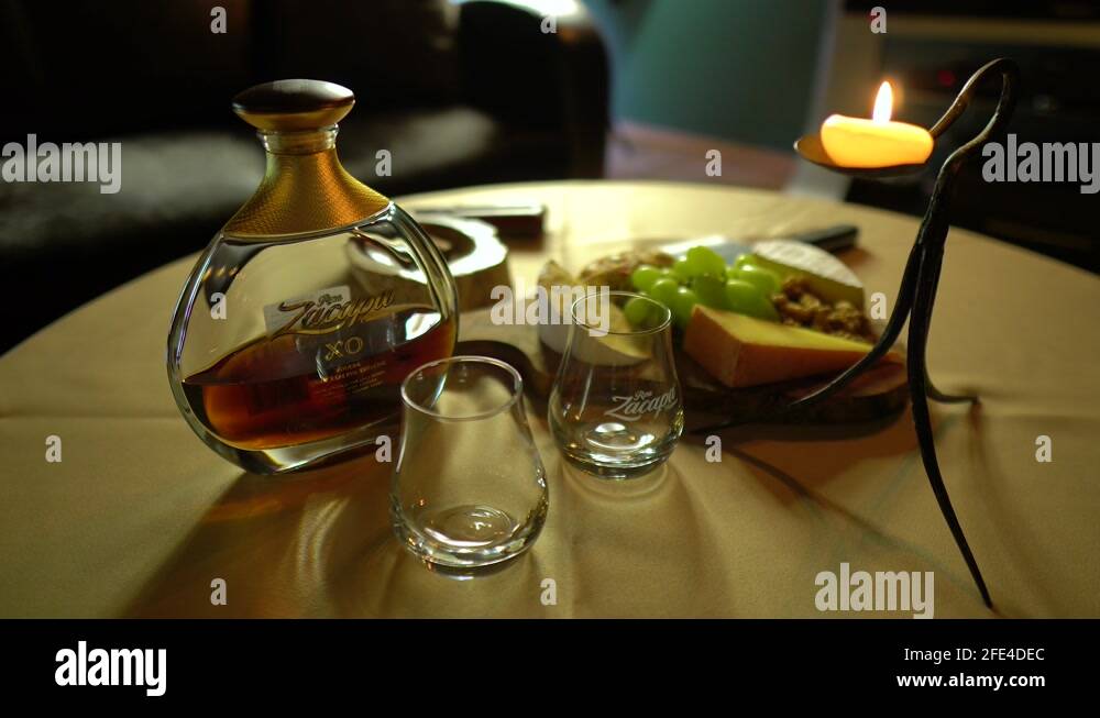 refreshments including Zacapa rum set on a table in mens club with dim ...