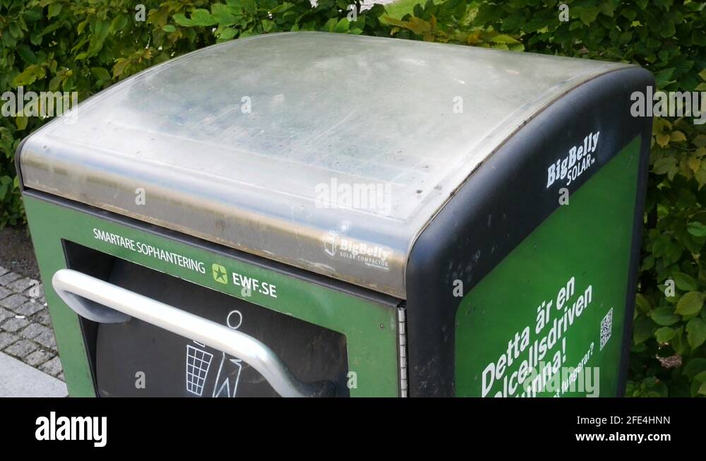 Solar panel cell driven public trash can that compress the trash and make Stock Video Footage
