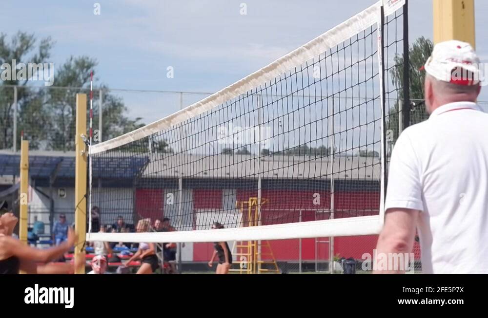Young girl makes a mistake in beach volleyball and gets very upset