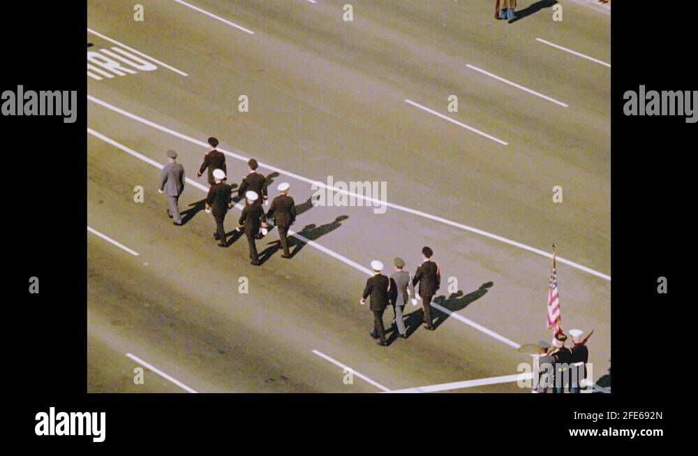 1960s From above, six white horses pulling the flag draped casket of