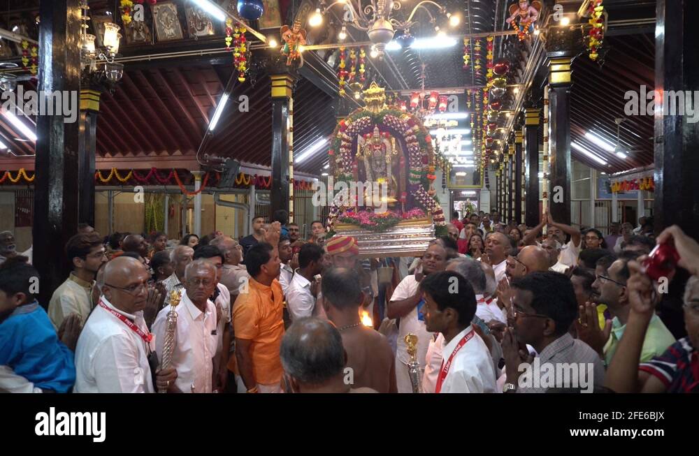Priest carry oil lamp during ritual of Lord Murugan statue Stock Video