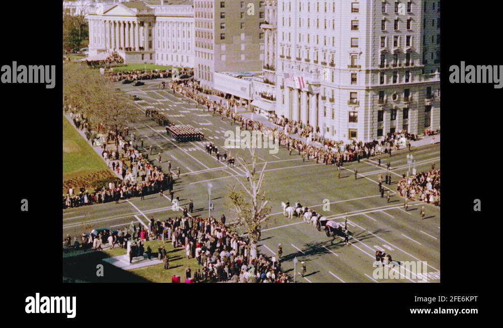 1960s From above, six white horses pulling the flag draped casket of