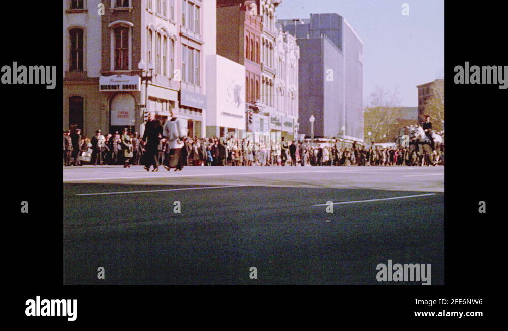 1960s Street level footage of six white horses pulling the flag draped