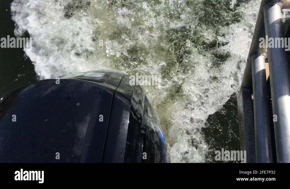 Outboard motor of boat churning the river water in a white froth Stock Video Footage Alamy