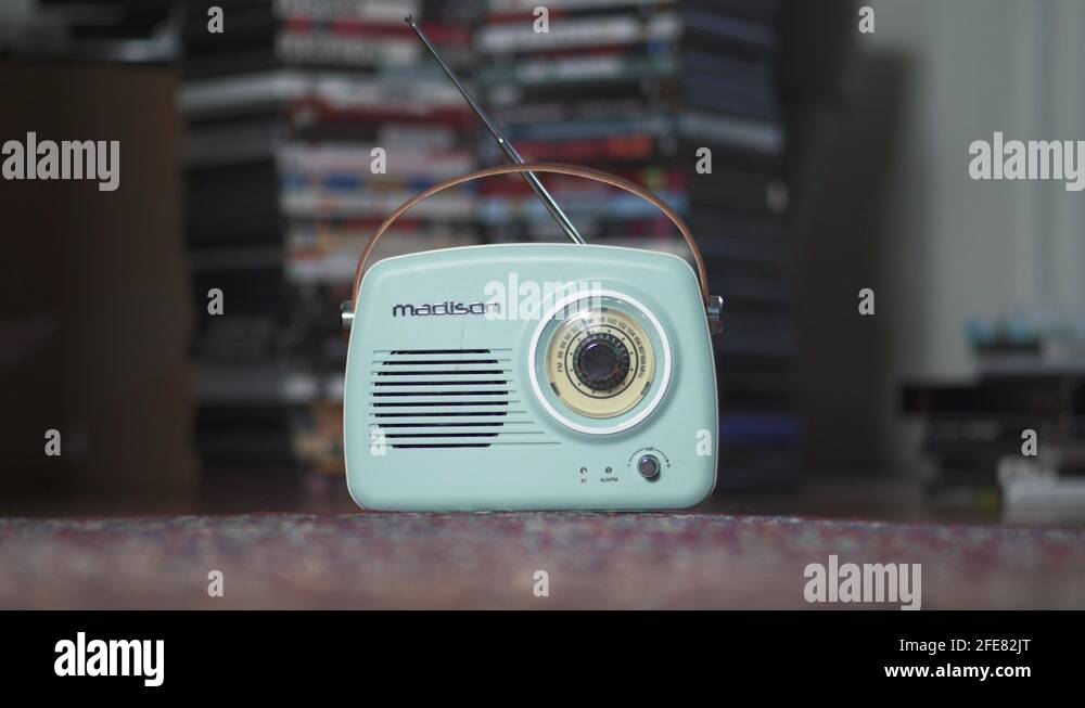 Turquoise mobile vintage radio playing music. Red light flashing. Close