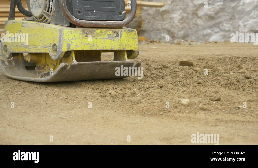 A Rattling Machine CLOSE UP: Rattling heavy duty levelling machine pounds the gravel ...