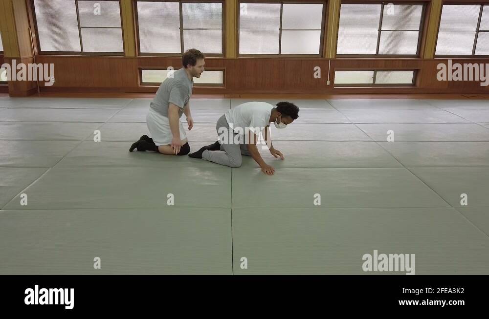 Ground restraint technique being demonstrated on gym floor Stock Video
