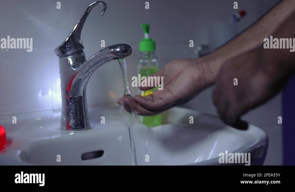 A man washing hands with hand wash in a wash basin Stock Video Footage