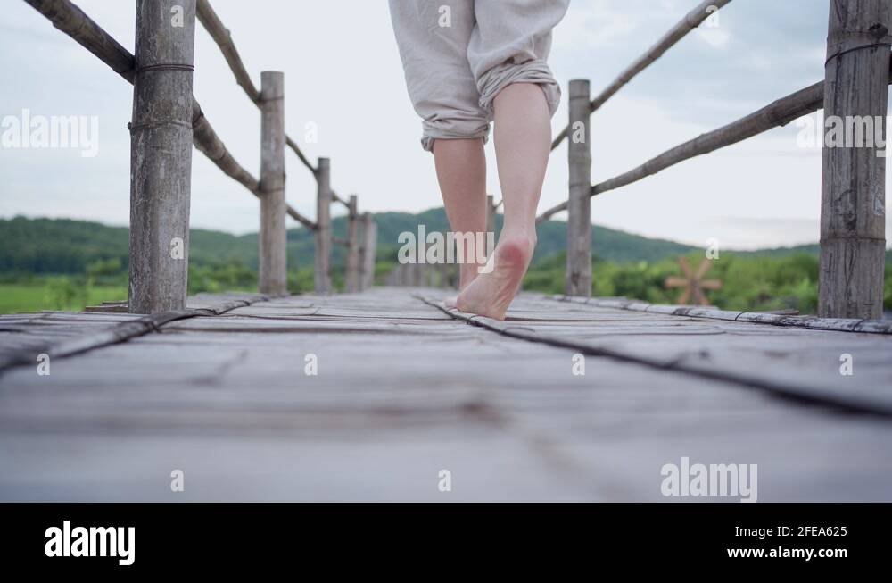 Female walking with barefoot on wooden bridge, Asian traditional ...