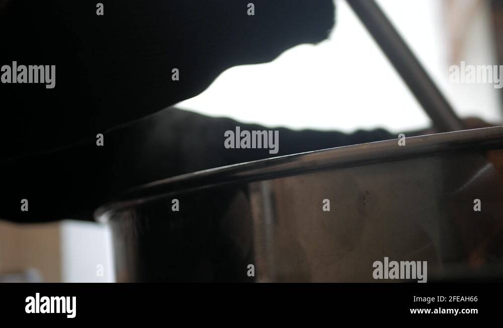 A beer brewer mixing his malt in the container. 4K Stock Video Footage