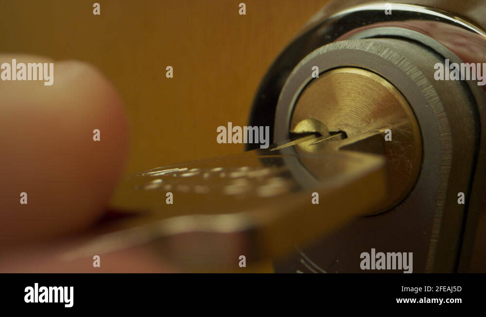 Key into lock, turn key Stock Video Footage Alamy