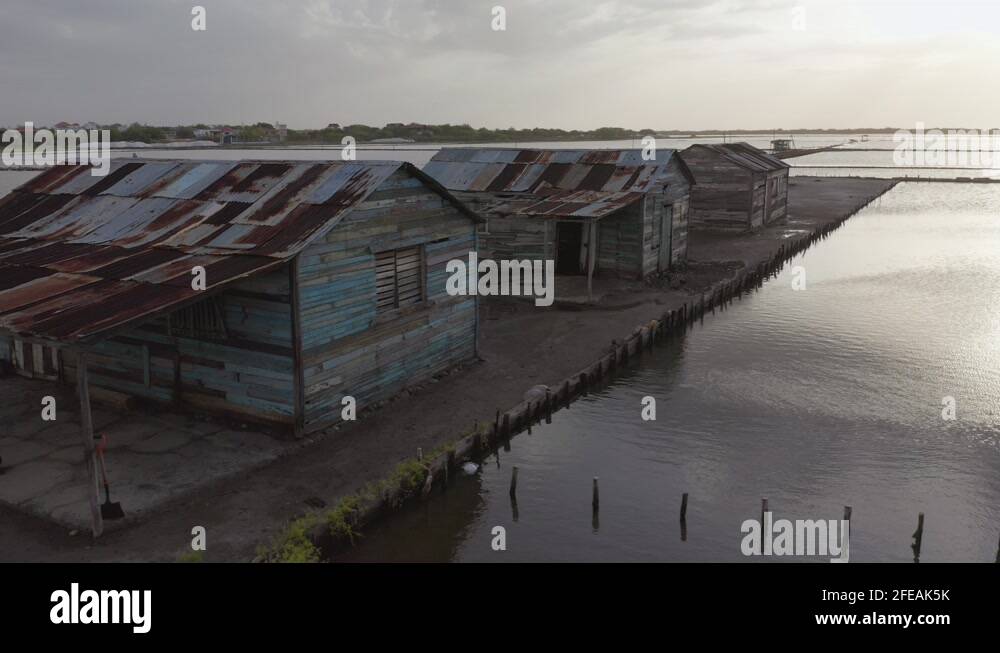 Three old houses in the salt mine of Bani, Dominican Republic, drone