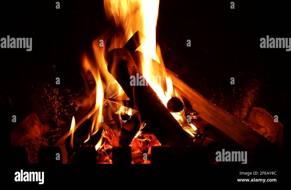 log fire burning in a fireplace brazier natural light close up Stock