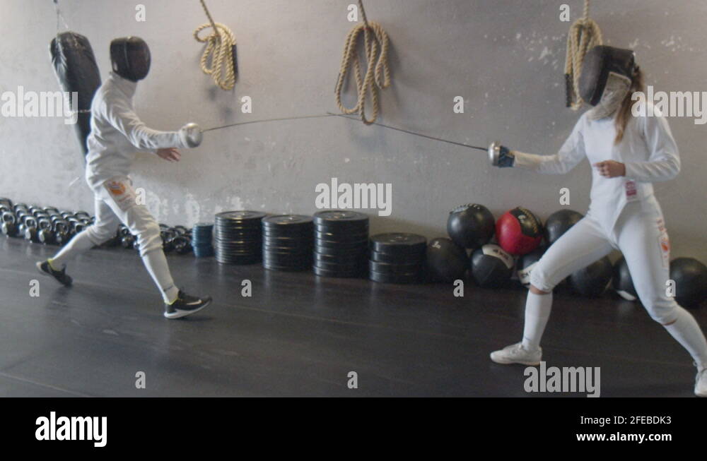 Female fencer deflecting attack with short counter and scoring point