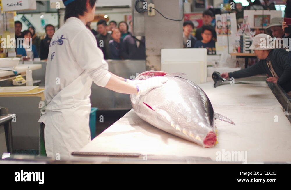 A Butcher To Cut The Head Of A Big Bluefin Tuna In Front Of Japanese