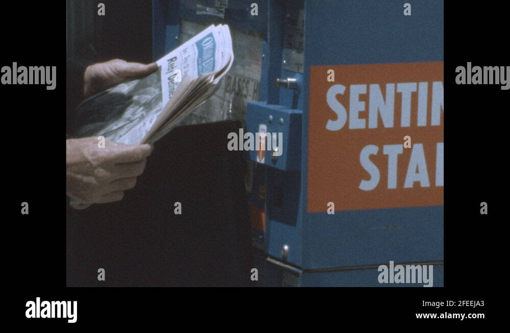 1970s Shots Of Hands Taking Newspaper From Vending Machine Tilt Up To 
