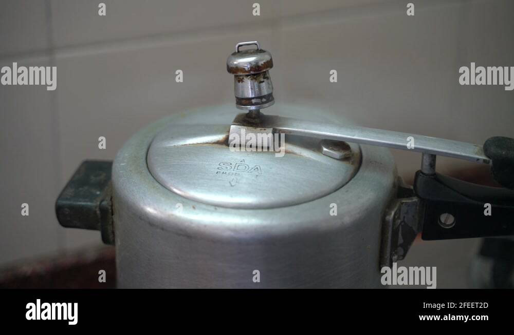 Steam Escaping From The Lid Of The Boiling Pressure Cooker On The