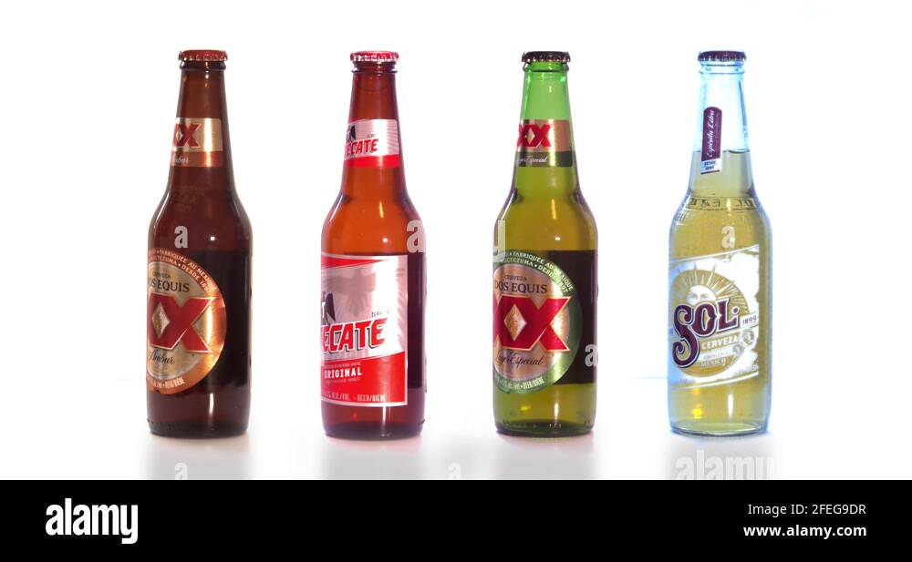 A beers of mexico tecate sol dos equis beer bottles on a white
