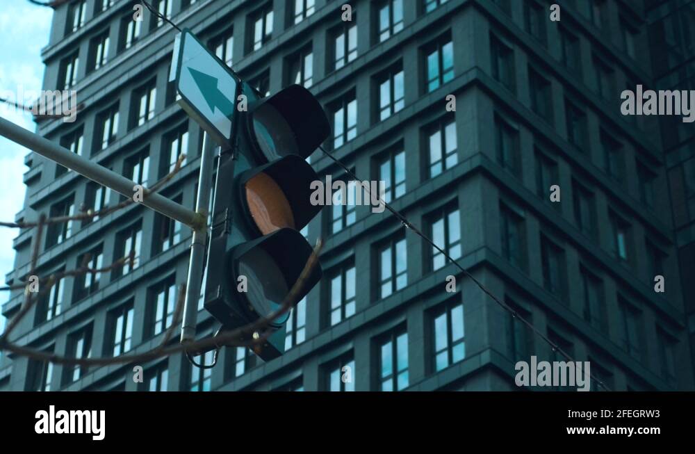 Traffic light turns from green to red. Semaphore near the downtown