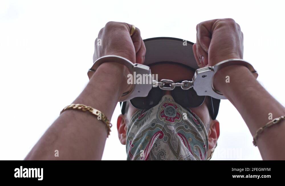 A man trying to unlock the shackles that bind them. Represents the pain