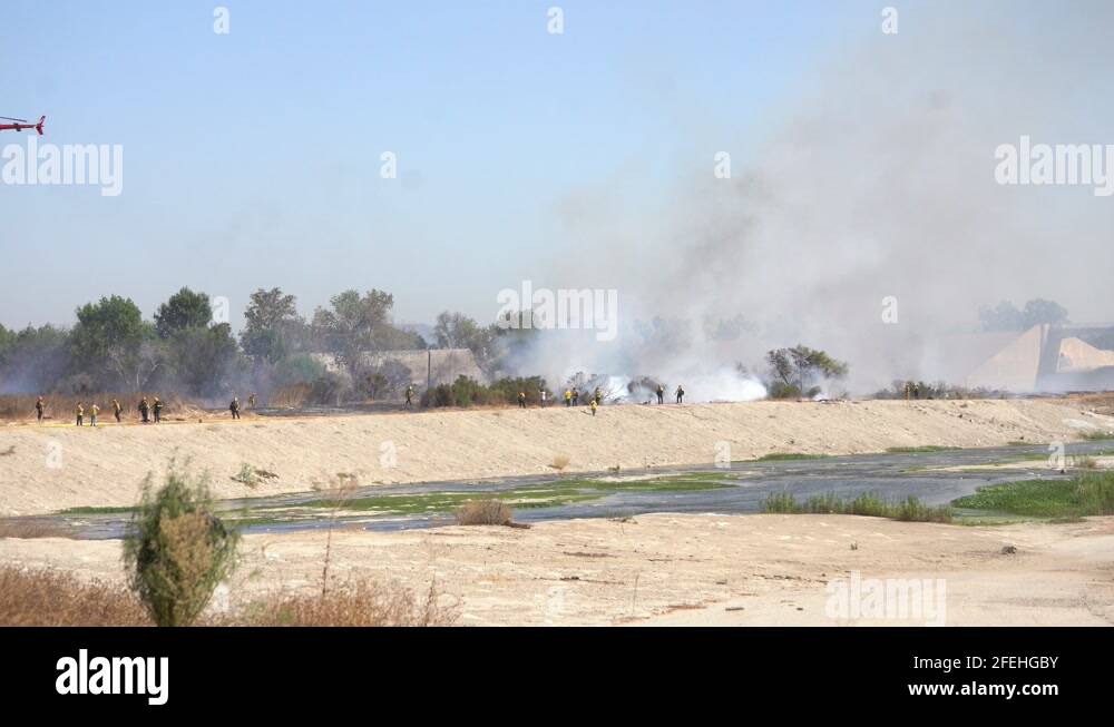 Firefighting helicopters dropping water on fire Stock Video Footage Alamy