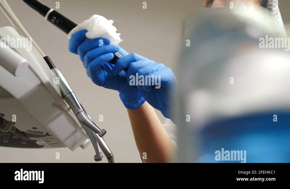 Dental assistant wipes medical devices and tools with disinfectant solution Stock Video Footage