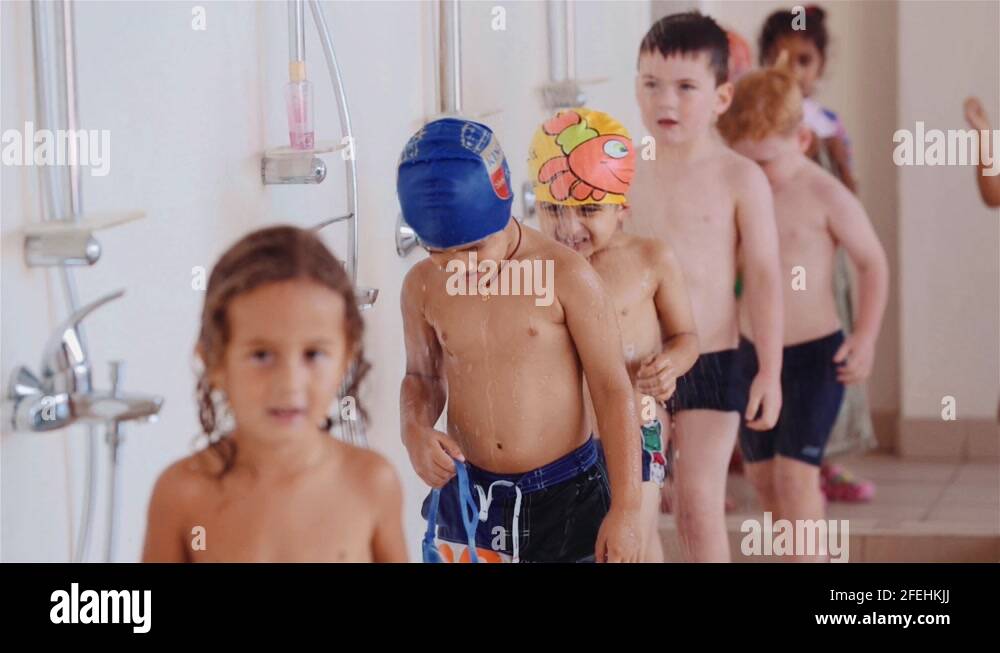 Children Taking A Shower Before Going Into The Swimming Pool For Their