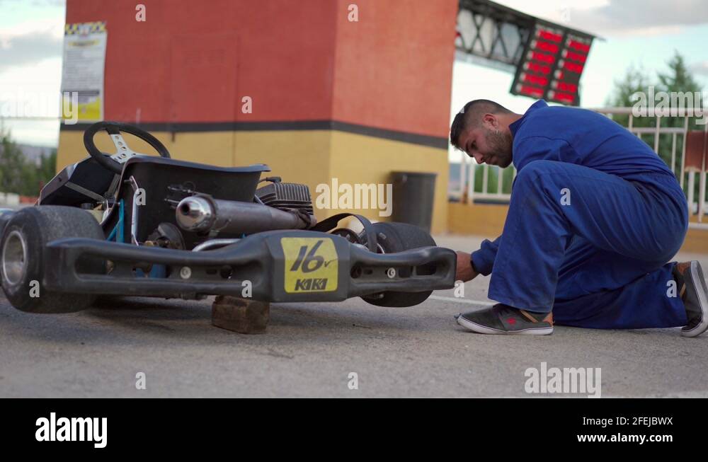 Go kart mechanic fixing a kart and changing a flat tire on a go kart