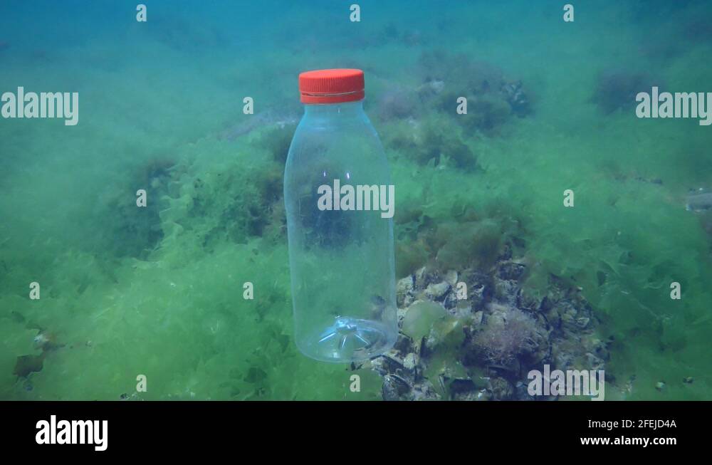 Plastic pollution of the sea PVC bottle slowly sinks to the bottom