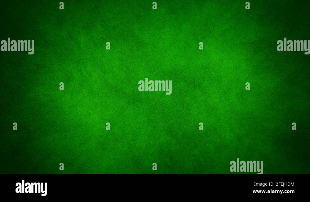 A spray of green paint paints over a black background forming a green