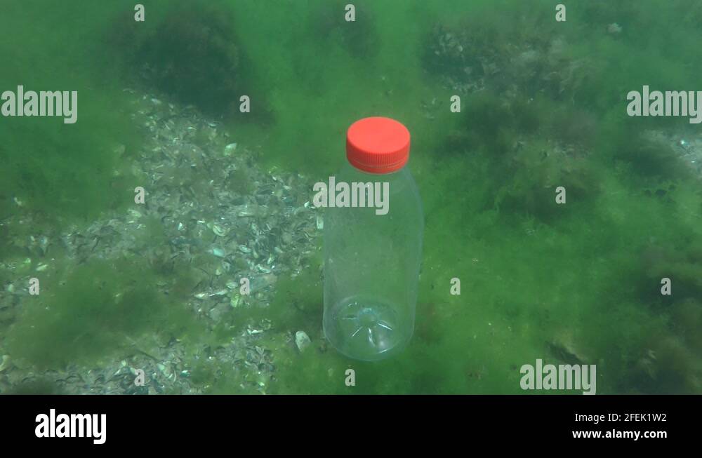 Plastic pollution of the sea PVC bottle slowly sinks to the bottom