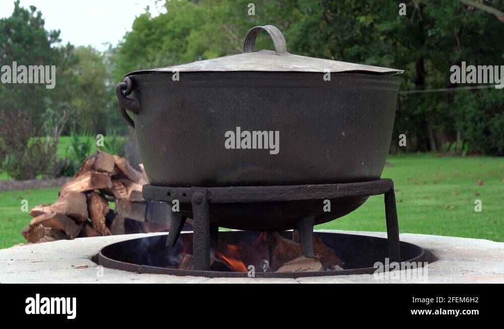 An old fashioned iron kettle over the fire of an outdoor campfire Stock ...