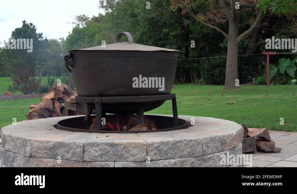 An old fashioned iron kettle over the fire of an outdoor campfire Stock Video Footage Alamy